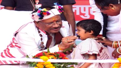 The Chief Minister sat the little girl on his lap and fed her laddus.