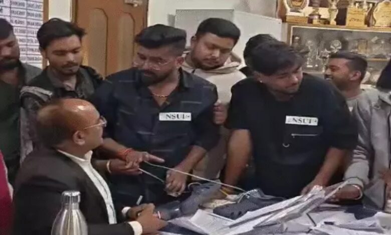 An NSUI leader attempted to garland the principal with shoes; police are searching for him.