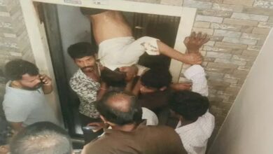 Leg trapped in lift, man left hanging between two floors; rescued by breaking through the wall.