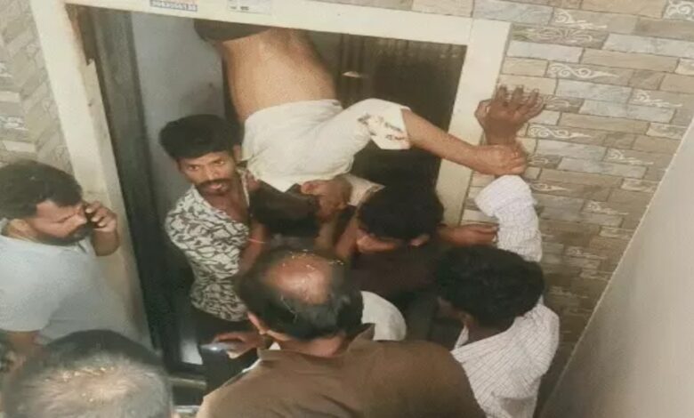 Leg trapped in lift, man left hanging between two floors; rescued by breaking through the wall.